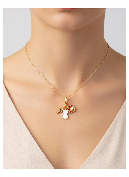 Charm dorado con gato blanco, huella roja y espina de pez en acero con baño de oro 18K sobre modelo