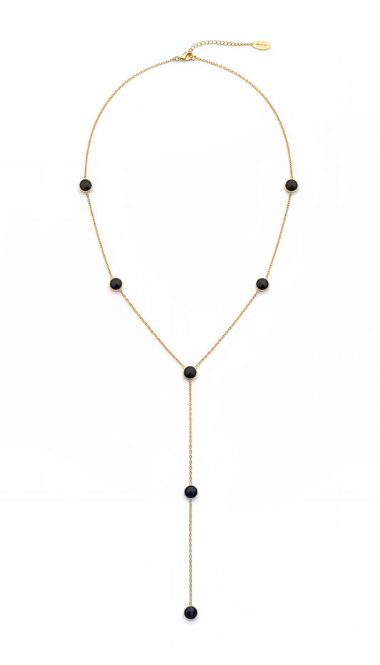 Collar lariat dorado con discos negros esmaltados en acero con baño de oro 18K