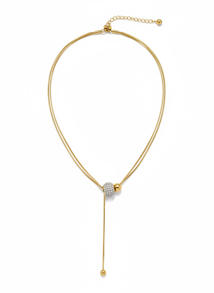 Collar lariat dorado con cuenta pavé y terminal esférico en acero con baño de oro 18K