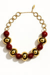 Collar luxury dorado con esferas burdeos y cadena de eslabones redondos