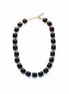 Collar dorado corto con cabujones negros talla cushion y alargador