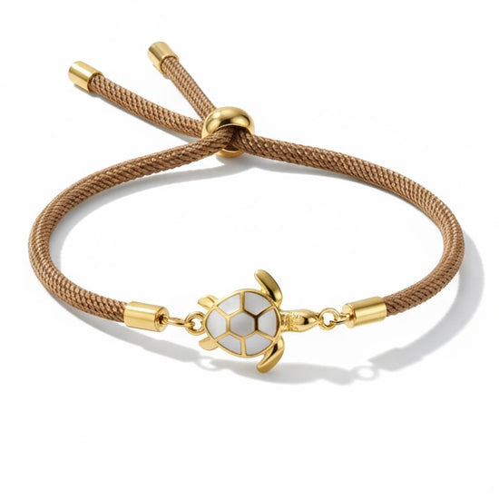 Pulsera Bravata con cordón marrón y tortuga central dorada esmaltada