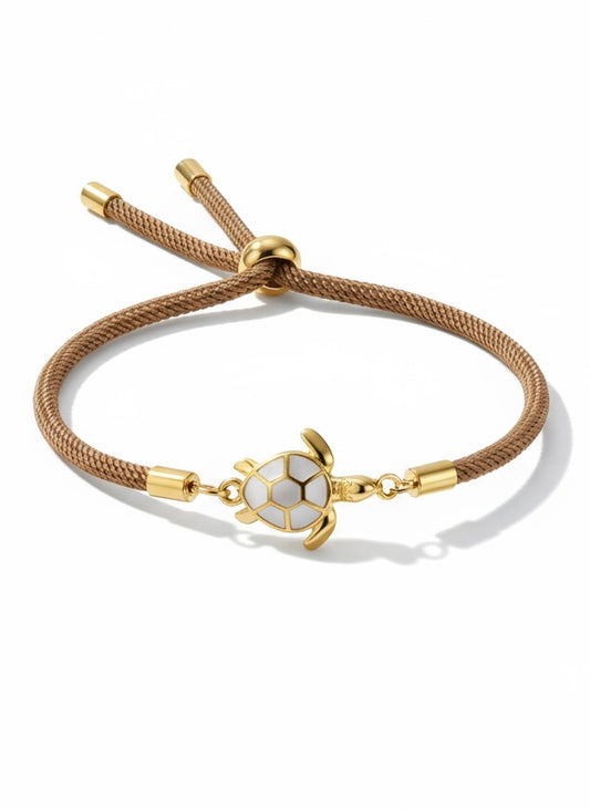 Pulsera Bravata con cordón marrón y tortuga central dorada esmaltada
