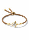 Pulsera Bravata de cordón arena con tortuga dorada y esmalte blanco