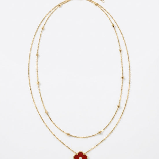 collar dorado de doble cadena con colgante de flor roja y detalle central brillante