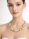 Mujer con collar Pebble bicolor de acero inoxidable en tonos dorado y plateado diseño orgánico elegante