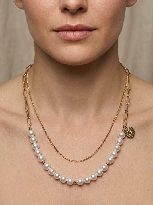 Collar de perlas con cadena dorada doble puesto en mujer estilo elegante y sofisticado Bravata