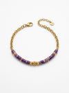pulsera dorada con cuentas moradas y detalles en oro elegante para mujer