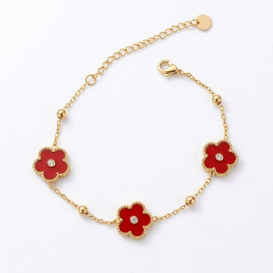 pulsera dorada con flores rojas esmaltadas y circonita central para mujer elegante