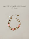 Pulsera dorada con detalles rosados y cápsula de recuerdos opcional Bravata